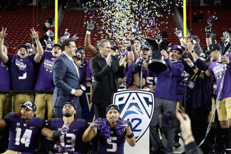 SANTA CLARA, CA - NOVEMBER 30: Head coach Chris Petersen of the Washington Huskies is given the championship trophy after the Huskies beat the Utah Utes to win the Pac 12 Championship game at Levi's Stadium on November 30, 2018 in Santa Clara, California. (Photo by Ezra Shaw/Getty Images)