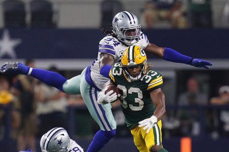 ARLINGTON, TEXAS - OCTOBER 06: Aaron Jones #33 of the Green Bay Packers evades Jaylon Smith #54 and Robert Quinn #58 of the Dallas Cowboys in the fourth quarter at AT&T Stadium on October 06, 2019 in Arlington, Texas. (Photo by Richard Rodriguez/Getty Images)