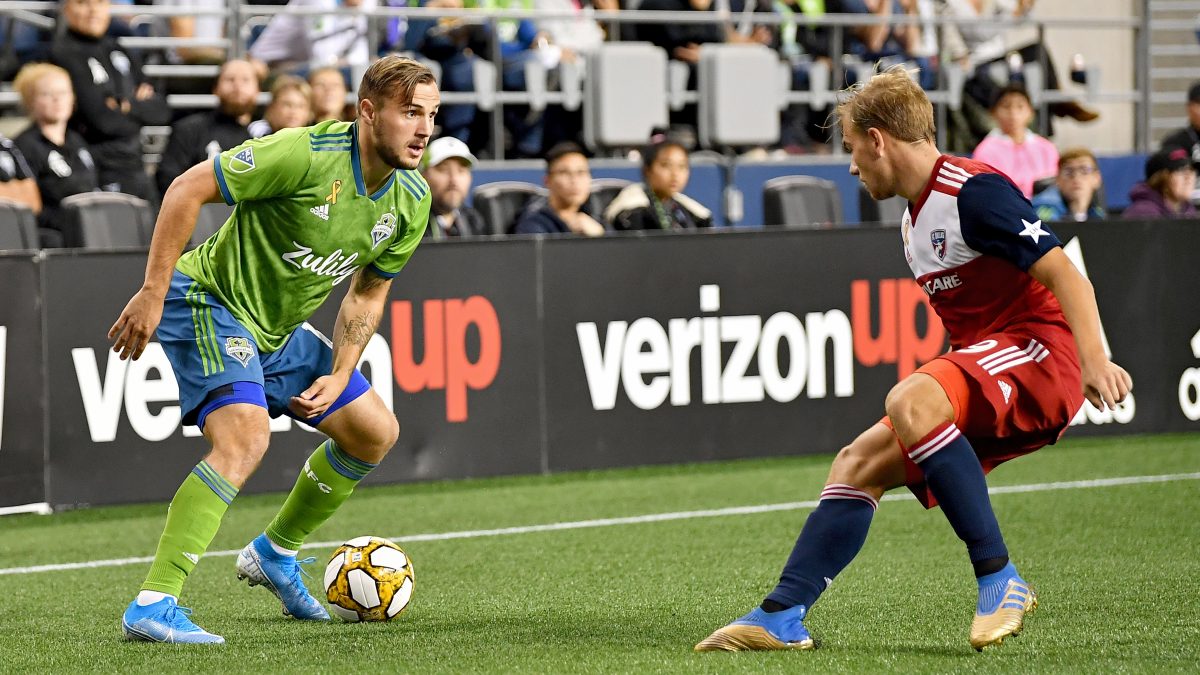 SEATTLE, WASHINGTON - SEPTEMBER 18: Jordan Morris #13 of Seattle Sounders looks to move the ball against Alex Muyl #19 of New York Red Bulls during the match at CenturyLink Field on September 18, 2019 in Seattle, Washington. The match ended in a 0-0 draw. (Photo by Alika Jenner/Getty Images)