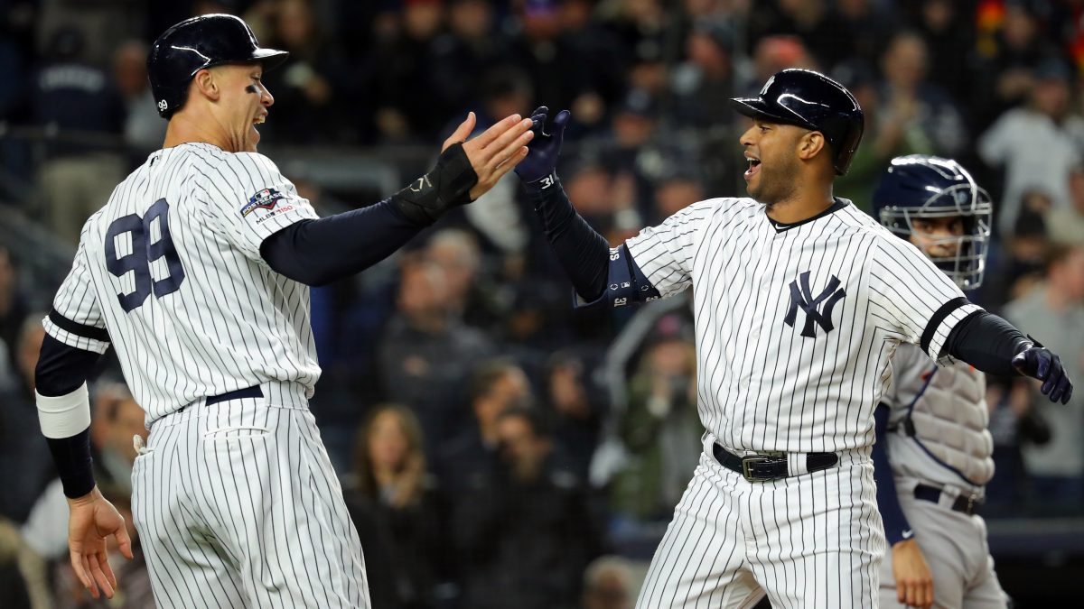 BRONX, NY - OCTOBER 18: Aaron Hicks #31 of the New York Yankees is greeted by teammate Aaron Judge #99 after hitting a three-run home run in the first inning during Game 5 of the ALCS between the Houston Astros and the New York Yankees at Yankee Stadium on Friday, October 18, 2019 in the Bronx borough of New York City. (Photo by Alex Trautwig/MLB Photos via Getty Images)
