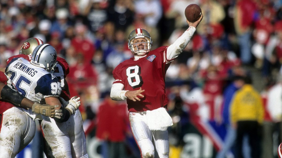 SAN FRANCISCO, CA - JANUARY 15, 1995: Quarterback Steve Young #8 of the San Francisco 49ers throws a pass against the Dallas Cowboys during the NFL conference championship football game January 15, 1995 at Candlestick Park in San Francisco, California. 49ers won the game 38-28. Young played for the 49ers from 1987-99. (Photo by Focus on Sport/Getty Images)