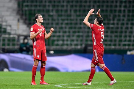 Bayern Munich's French defender Benjamin Pavard (R) celebrates with his teammate Bayern Munich's German midfielder Leon Goretzka after the German first division Bundesliga football match SV Werder Bremen v FC Bayern Munich on June 16, 2020 in Bremen, northern Germany. - Bayern Munich were crowned German Bundesliga champions for the eight year in a row on June 16, 2020 after their away win against Bremen. (Photo by Martin MEISSNER / POOL / AFP) / DFL REGULATIONS PROHIBIT ANY USE OF PHOTOGRAPHS AS IMAGE SEQUENCES AND/OR QUASI-VIDEO (Photo by MARTIN MEISSNER/POOL/AFP via Getty Images)