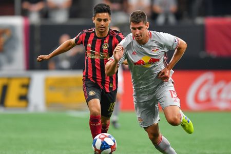 ATLANTA, GA JULY 07: NewYork's Sean Nealis (15) takes the ball away from Atlanta's Gonzalo "Pity" Martínez (10) during the MLS match between the New York Red Bulls and Atlanta United FC July 7th, 2019 at Mercedes Benz Stadium in Atlanta, GA. (Photo by Rich von Biberstein/Icon Sportswire via Getty Images)