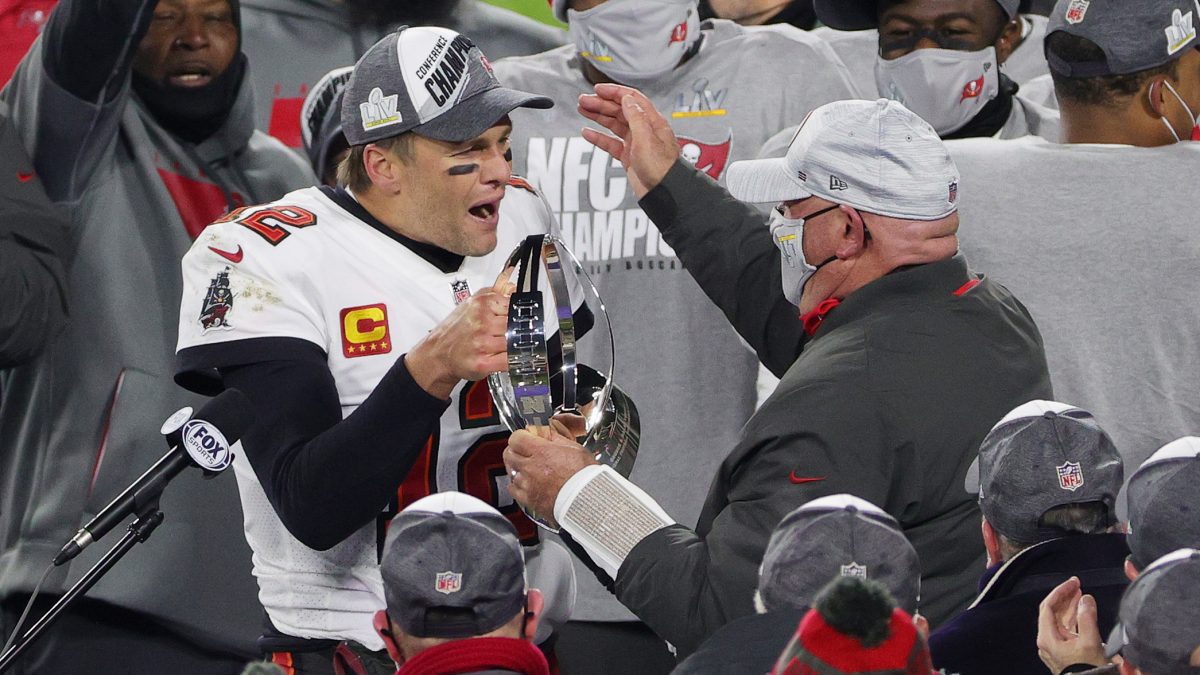 GREEN BAY, WISCONSIN - JANUARY 24: Tom Brady #12 of the Tampa Bay Buccaneers celebrates with head coach Bruce Arians and teammates after their 31 to 26 win over the Green Bay Packers during the NFC Championship game at Lambeau Field on January 24, 2021 in Green Bay, Wisconsin. (Photo by Stacy Revere/Getty Images)