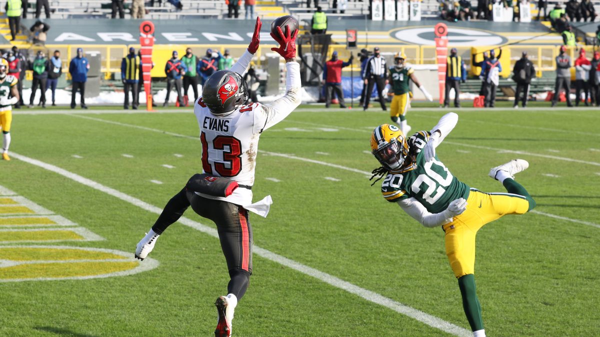 GREEN BAY, WISCONSIN - JANUARY 24: Mike Evans #13 of the Tampa Bay Buccaneers completes a reception for a touchdown in the first quarter against the Green Bay Packers during the NFC Championship game at Lambeau Field on January 24, 2021 in Green Bay, Wisconsin. (Photo by Dylan Buell/Getty Images)