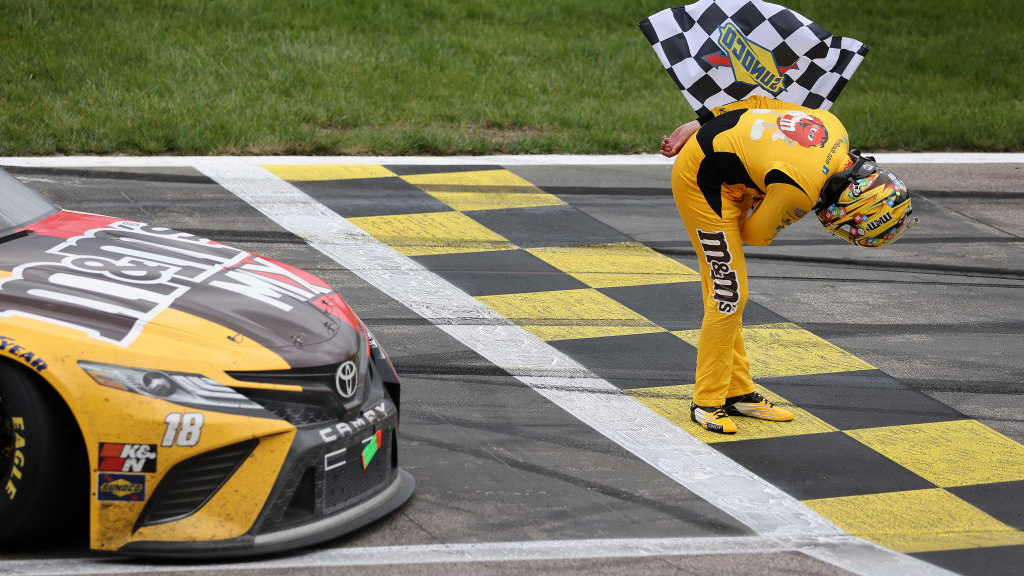 KANSAS CITY, KANSAS - MAY 02: Kyle Busch, driver of the #18 M&M's Mix Toyota, takes a bow after winning the NASCAR Cup Series Buschy McBusch Race 400 at Kansas Speedway on May 02, 2021 in Kansas City, Kansas. (Photo by James Gilbert/Getty Images)