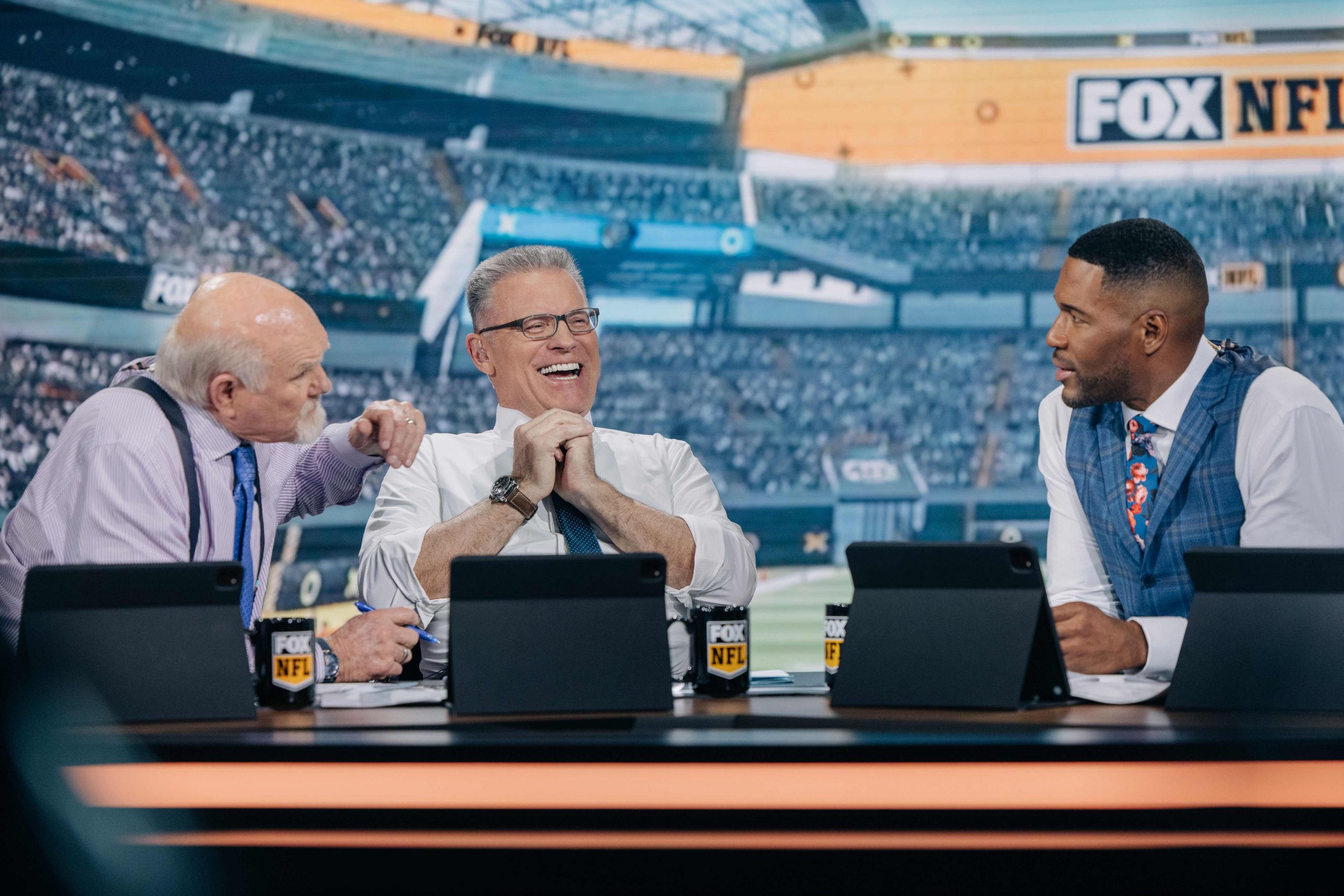 Howie Long sharing a laugh with Bradshaw and Strahan